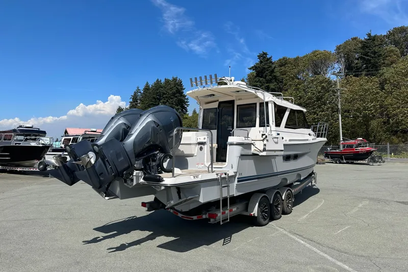  Yacht Photos Pics 2026 Cutwater C-32 C boat on trailer, dual outboard motors, parked outdoors.