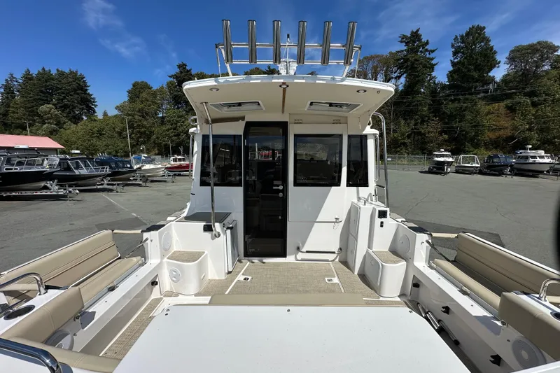  Yacht Photos Pics 2026 Cutwater C-32 C boat interior with seating, docked outdoors.