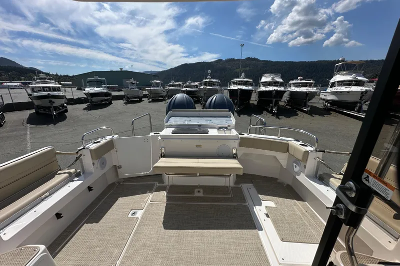  Yacht Photos Pics 2026 Cutwater C-32 C boat interior with marina view, showcasing spacious seating and modern design.