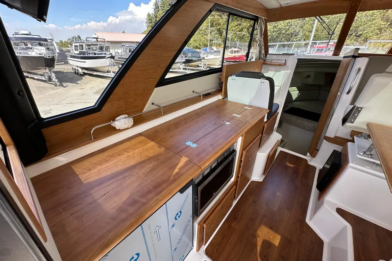  Yacht Photos Pics Interior of 2026 Cutwater C-32 C boat with wood finish and modern amenities.