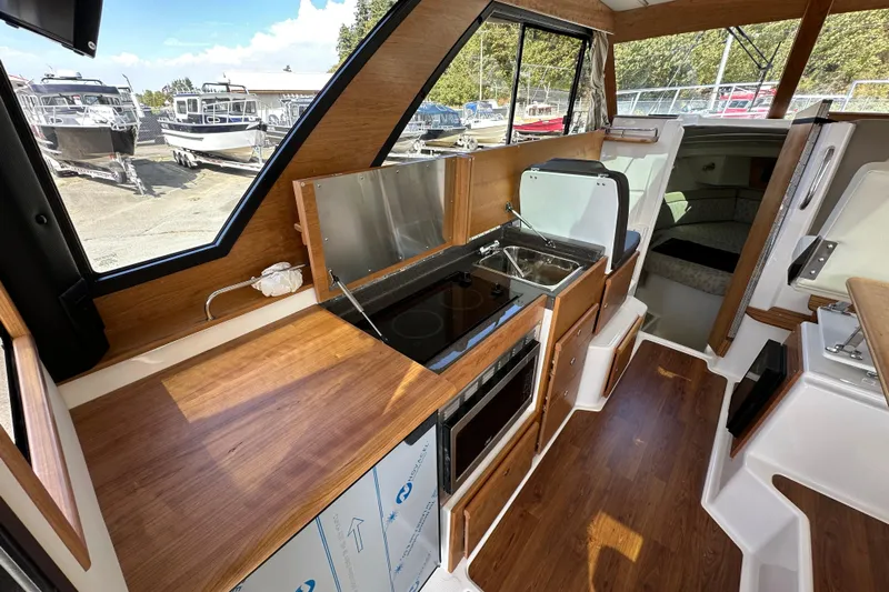  Yacht Photos Pics 2026 Cutwater C-32 C interior with modern kitchen and wood finish.