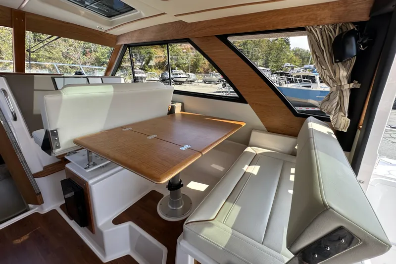  Yacht Photos Pics Interior of 2026 Cutwater C-32 C boat with dining area and large windows.