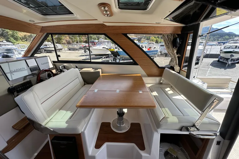  Yacht Photos Pics Interior of 2026 Cutwater C-32 C boat with seating and navigation equipment.
