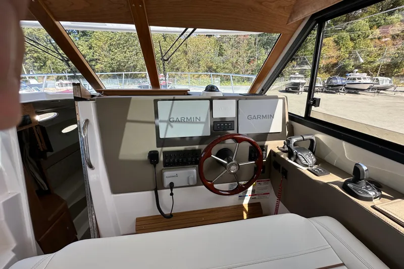  Yacht Photos Pics Interior of 2026 Cutwater C-32 C boat with Garmin navigation system and steering wheel.