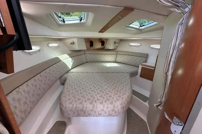  Yacht Photos Pics 2026 Cutwater C-32 C cabin interior with cushioned seating and overhead windows.