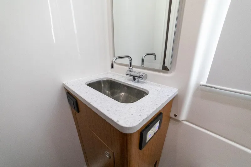  Yacht Photos Pics Manufacturer Provided Image: 2022 Solace 41 CS bathroom sink with modern faucet and mirror.