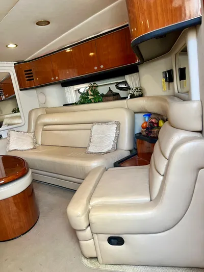 Party Of 9 Yacht Photos Pics Luxurious interior of a 2004 Sea Ray 46 Sundancer yacht with leather seating and wooden accents.