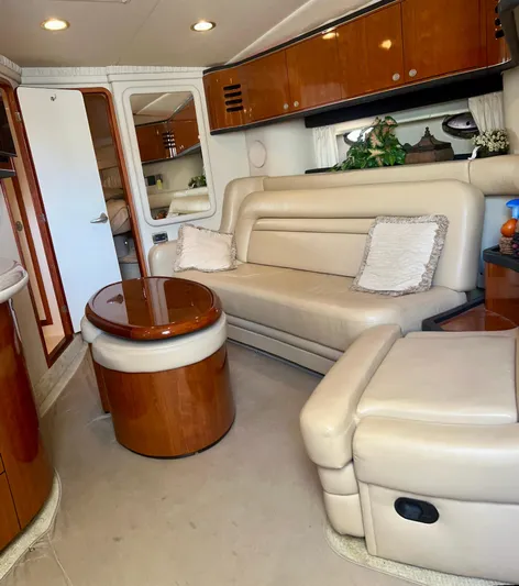 Party Of 9 Yacht Photos Pics Luxurious interior of a 2004 Sea Ray 46 Sundancer yacht with beige leather seating.
