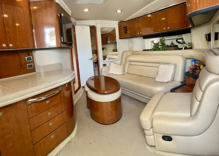 Party Of 9 Yacht Photos Pics Luxurious interior of 2004 Sea Ray 46 SUNDANCER yacht with leather seating and wooden cabinetry.