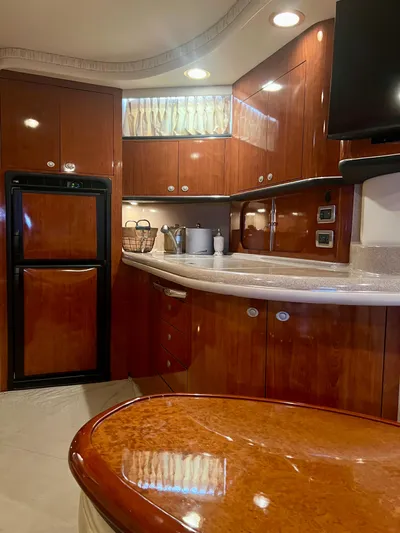 Party Of 9 Yacht Photos Pics Luxurious 2004 Sea Ray 46 SUNDANCER yacht interior with polished wood cabinetry and modern amenities.