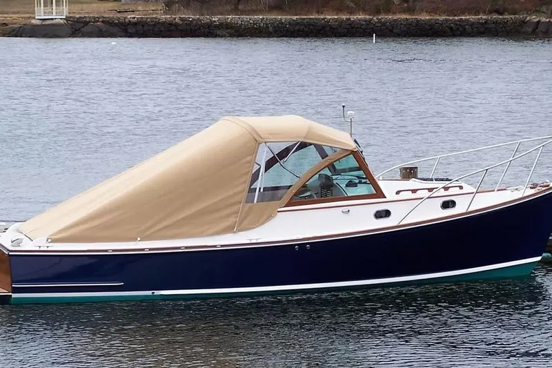 Elan II Yacht Photos Pics 2008 Wasque 26 boat with tan canopy, docked on calm water.