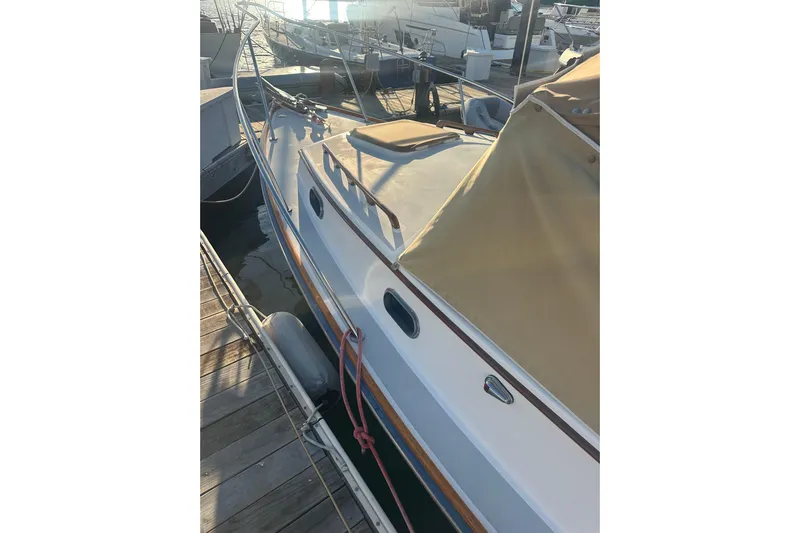 Elan II Yacht Photos Pics 2008 Wasque 26 boat docked at marina, featuring tan cover and sleek design.