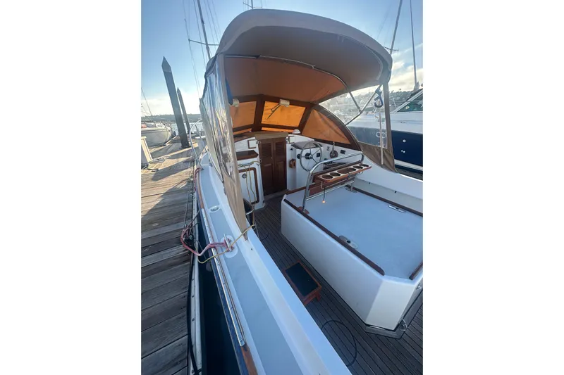 Elan II Yacht Photos Pics 2008 Wasque 26 boat docked, featuring a covered cockpit and wooden accents.