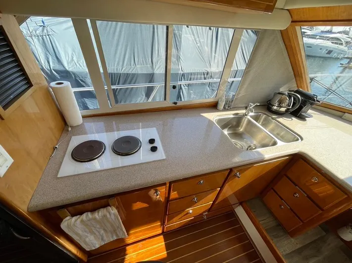 "spirit Island" Yacht Photos Pics Navigator 4400 pilot house 2004 kitchen with stove, sink, and wooden cabinetry.
