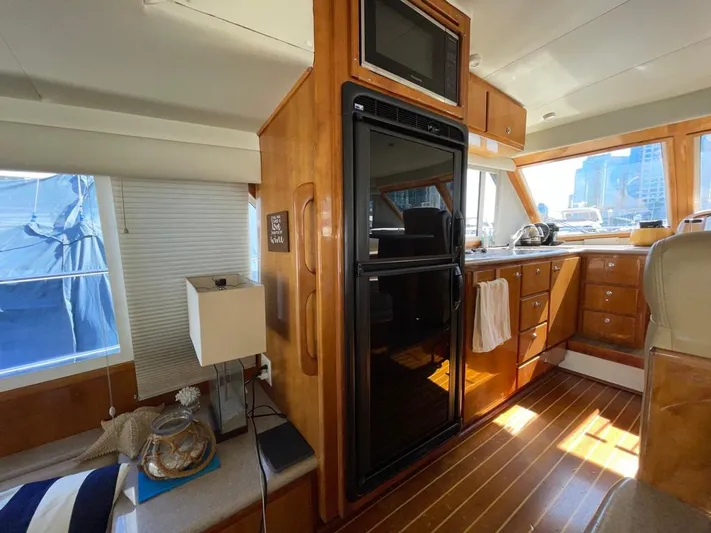 "spirit Island" Yacht Photos Pics 2004 Navigator 4400 Pilot House interior with wood finish, kitchen area, and seating.