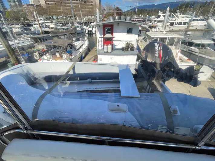 "spirit Island" Yacht Photos Pics 2004 Navigator 4400 Pilot House yacht with docked boats in marina background.