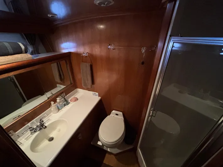 "spirit Island" Yacht Photos Pics Bathroom interior of 2004 Navigator 4400 Pilot House yacht, featuring sink, toilet, and shower.