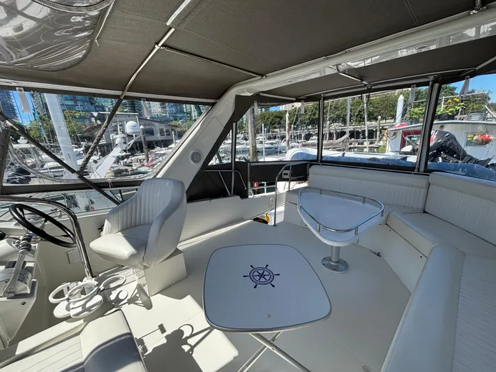 "spirit Island" Yacht Photos Pics 2004 Navigator 4400 Pilot House interior with seating, steering wheel, and marina view.