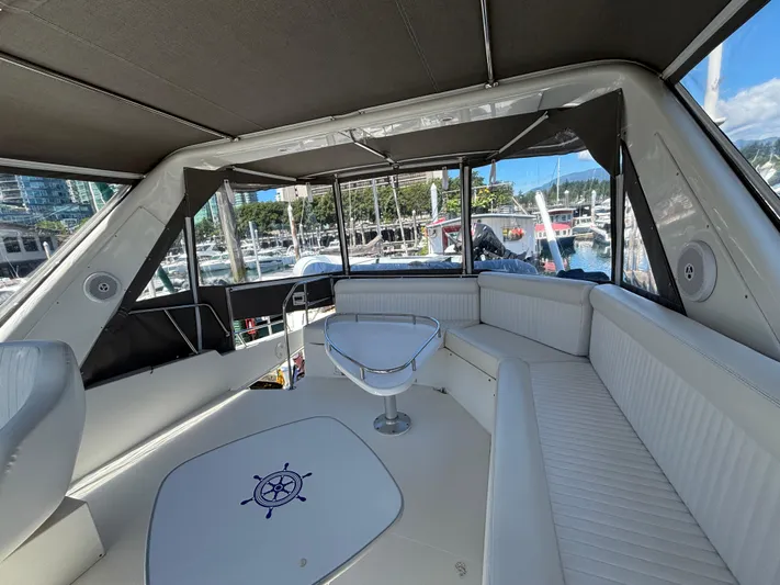 "spirit Island" Yacht Photos Pics Luxurious interior of 2004 Navigator 4400 pilot house yacht with white seating and marina view.