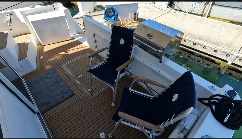 "spirit Island" Yacht Photos Pics 2004 Navigator 4400 pilot house deck with chairs and grill, dockside view.