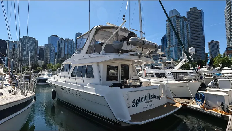 "spirit Island" Yacht Photos Pics 2004 Navigator 4400 Pilot House yacht docked in a marina with city skyline backdrop.