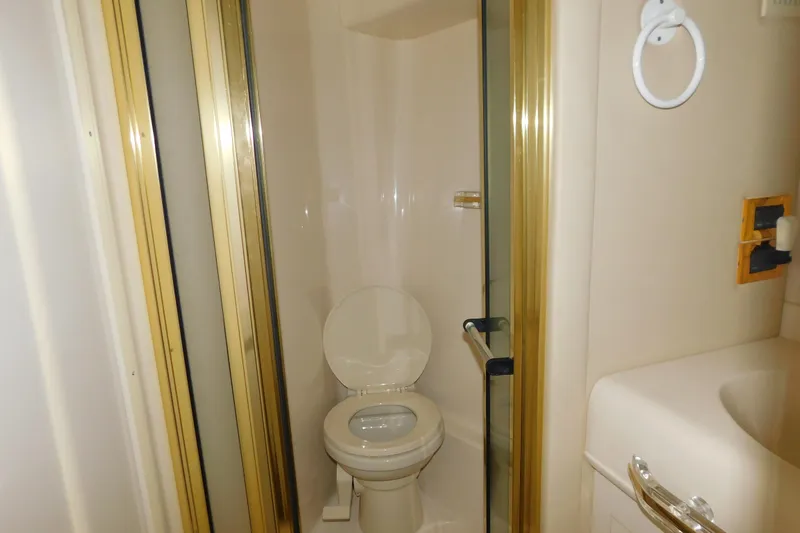  Yacht Photos Pics Bathroom interior of 1999 Sea Ray 500 Sundancer yacht, featuring toilet and shower.