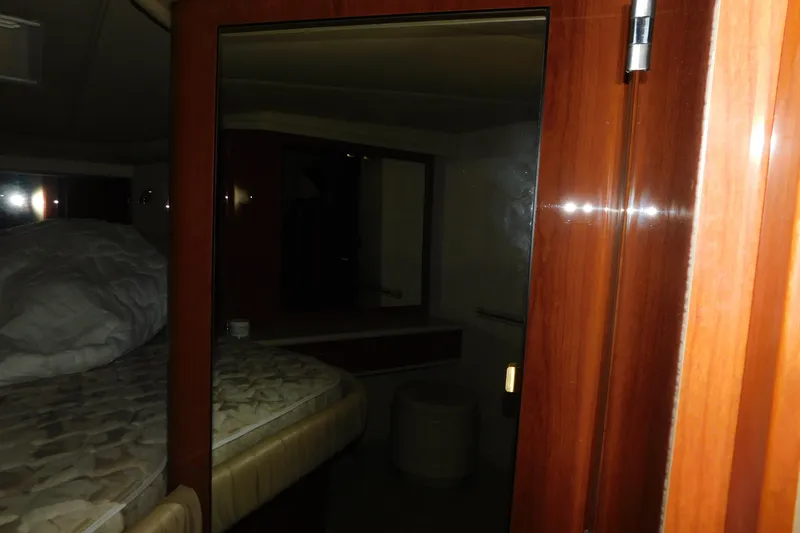  Yacht Photos Pics 1999 Sea Ray 500 Sundancer cabin interior with wooden finishes and bed.