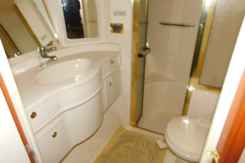  Yacht Photos Pics Bathroom interior of 1999 Sea Ray 500 Sundancer yacht, featuring sink and shower.