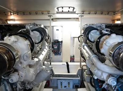 My Way Yacht Photos Pics Engine room of a 1999 Viking Express boat, showcasing dual engines and mechanical components.