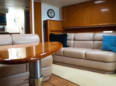My Way Yacht Photos Pics Luxurious interior of a 1999 Viking Express yacht with leather seating and wooden accents.