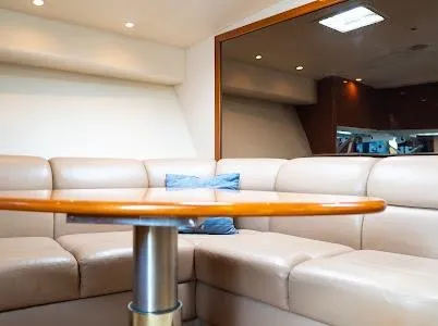 My Way Yacht Photos Pics Luxurious interior of 1999 Viking Express yacht with beige leather seating and wooden table.