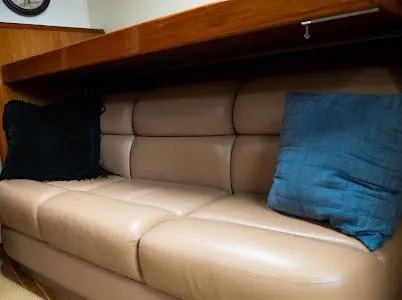 My Way Yacht Photos Pics 1999 Viking Express interior with beige leather sofa and blue cushions.