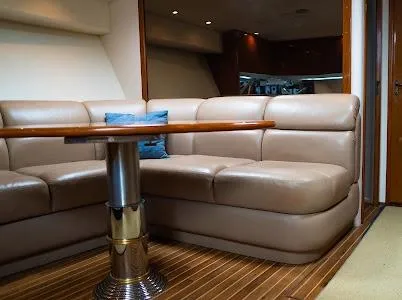 My Way Yacht Photos Pics Luxurious interior of 1999 Viking Express yacht with leather seating and wooden table.