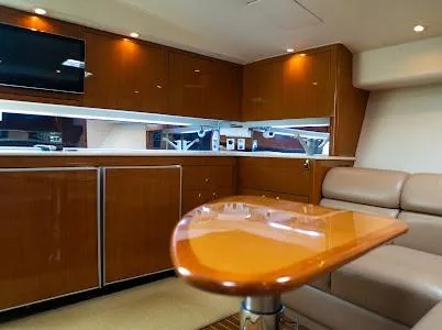 My Way Yacht Photos Pics Luxurious interior of a 1999 Viking Express yacht with wooden cabinetry and plush seating.