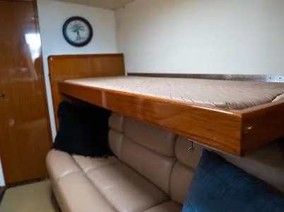 My Way Yacht Photos Pics Interior of 1999 Viking Express with leather seating and wooden bunk bed.