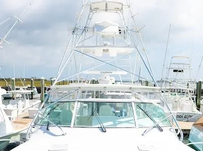 My Way Yacht Photos Pics 1999 Viking Express boat docked at marina under cloudy sky.