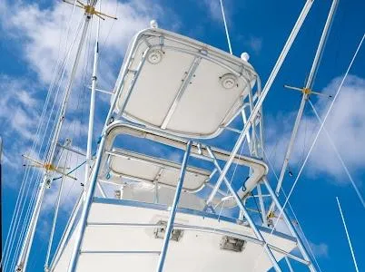 My Way Yacht Photos Pics 1999 Viking Express boat tower against a blue sky with clouds.