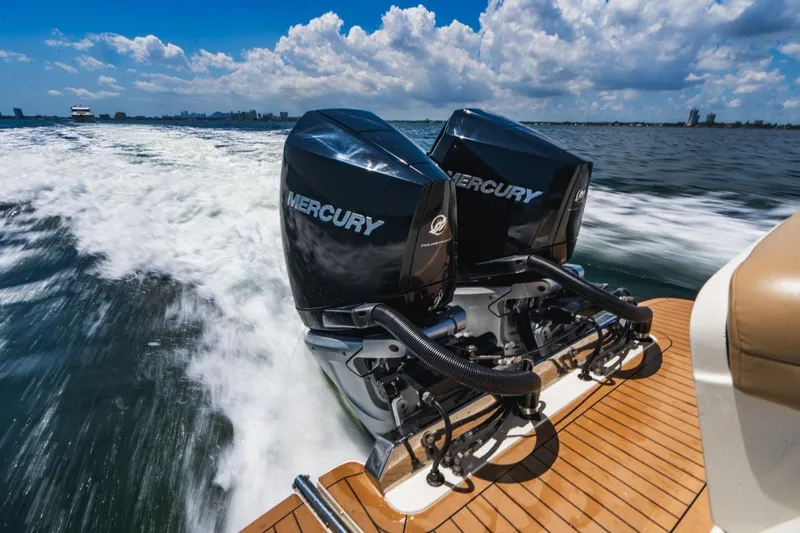  Yacht Photos Pics 2022 Scout 305 LXF boat with dual Mercury engines cruising on open water.