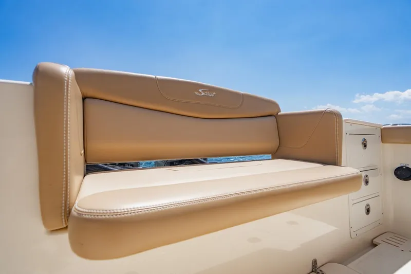  Yacht Photos Pics 2022 Scout 305 LXF boat seat with tan upholstery under clear blue sky.