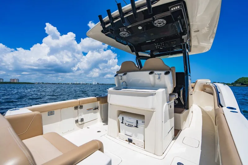  Yacht Photos Pics 2022 Scout 305 LXF boat interior with seating, ocean view, and clear blue sky.