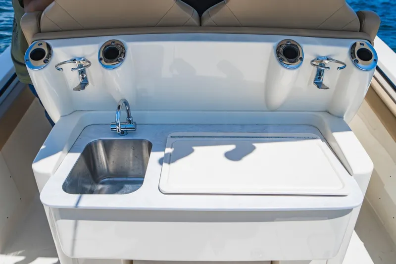  Yacht Photos Pics 2022 Scout 305 LXF boat sink and prep station with rod holders.