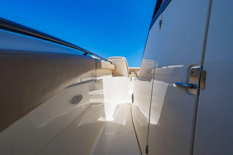  Yacht Photos Pics 2022 Scout 305 LXF boat interior with sleek design and blue sky background.