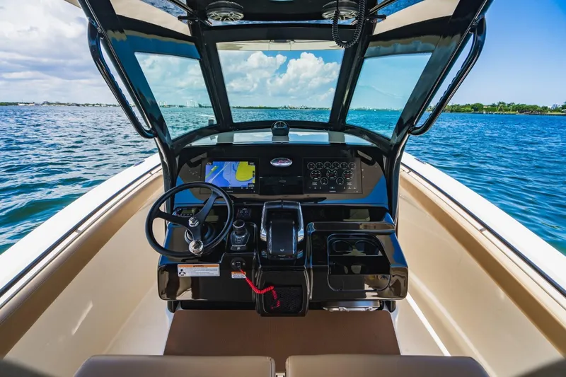  Yacht Photos Pics 2022 Scout 305 LXF boat cockpit with modern navigation system on open water.