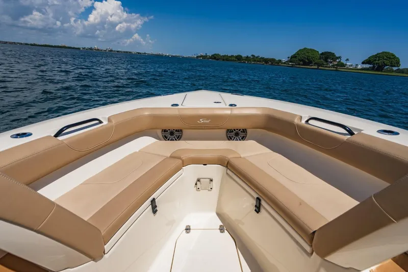  Yacht Photos Pics 2022 Scout 305 LXF boat interior with tan seating, on a sunny day at sea.