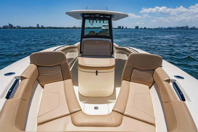  Yacht Photos Pics 2022 Scout 305 LXF boat with luxurious seating on open water.
