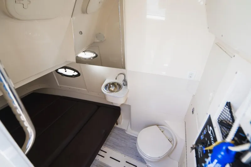  Yacht Photos Pics 2022 Scout 305 LXF cabin interior with bed, sink, and toilet.