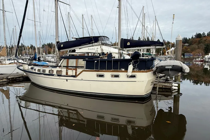  Yacht Photos Pics 1980 Nauticat Pilothouse sailboat docked in a marina, surrounded by other boats.