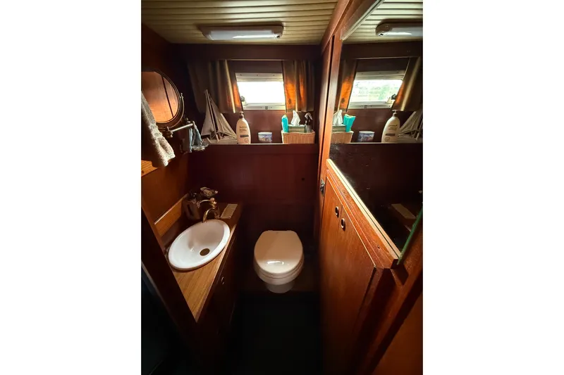  Yacht Photos Pics 1980 Nauticat Pilothouse bathroom with wooden interior, sink, and toilet.