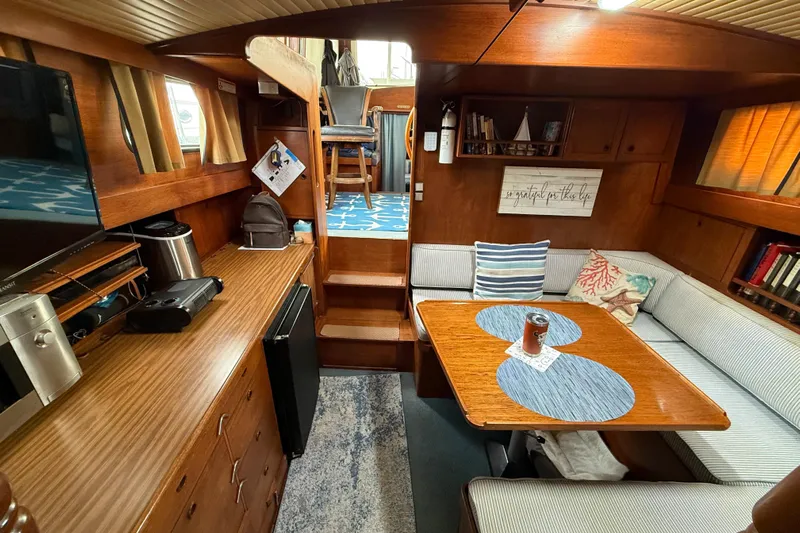  Yacht Photos Pics 1980 Nauticat Pilothouse interior with cozy seating, wooden cabinetry, and nautical decor.