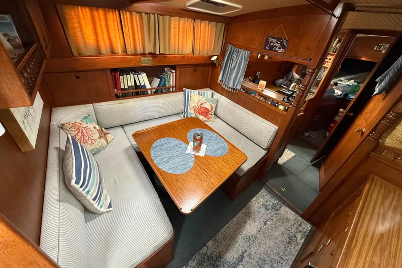  Yacht Photos Pics 1980 Nauticat Pilothouse interior with cozy seating, wooden table, and nautical decor.